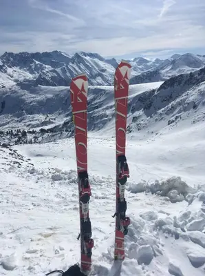 two skis standing in the snow with mountains in the background at Pirin Sunrise in Bansko
