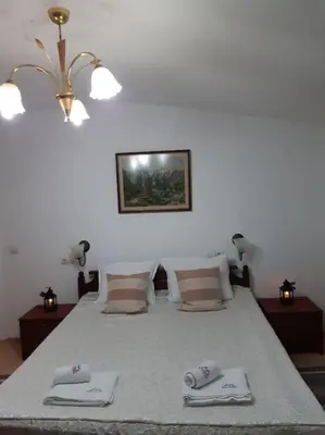 a bedroom with a bed with two napkins on it at Gondola lift apartment in Bansko