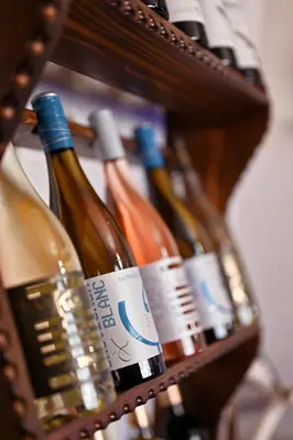 a bunch of wine bottles in a basket at Хотел Феникс in Chepelare