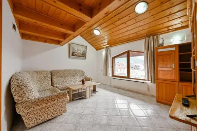 a living room with a couch and a table at Хотел Феникс in Chepelare