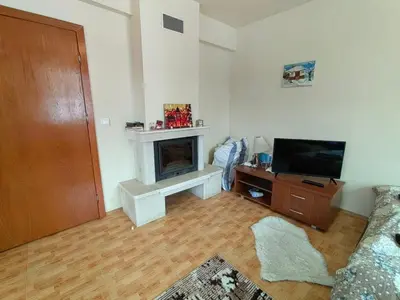 a living room with a fireplace and a television at Apartment Love Pamporovo in Pamporovo