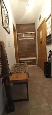 a room with a bench and a room with a door at Апартамент Bella Casa in Beli Iskar