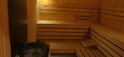 an empty wooden sauna with the lights on at Апартамент Bella Casa in Beli Iskar