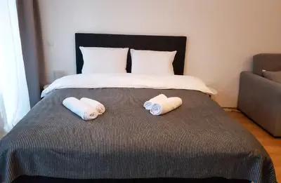 a bed with two pillows on it with a bed at Semiramida Garden Apartment 12 in Borovets