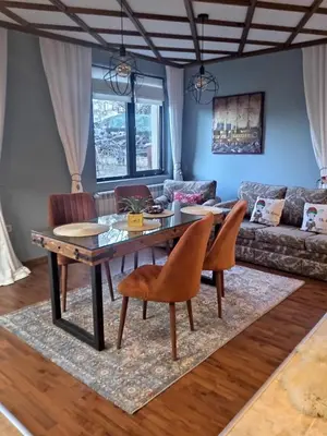 a dining room with a table and chairs at Mila VIP Apartment in Bansko