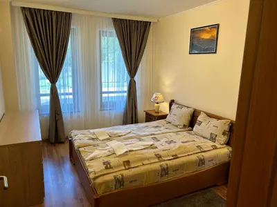a bedroom with a bed in front of a window at Charming apartmnet near Gondola and Bar street in Bansko