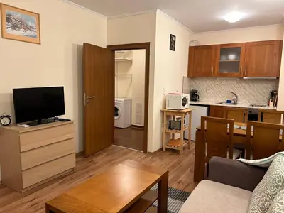 a small living room with a kitchen and a living room at Charming apartmnet near Gondola and Bar street in Bansko
