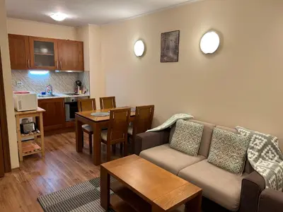 a living room with a couch and a table at Charming apartmnet near Gondola and Bar street in Bansko