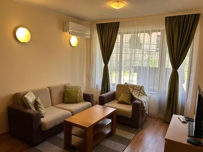 a living room with two couches and a coffee table at Charming apartmnet near Gondola and Bar street in Bansko