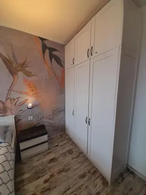 a bedroom with white cabinets and a painting on the wall at Belvedere Holiday Club h 305 in Bansko
