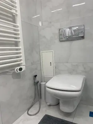 a bathroom with a white toilet and a sink at Studio Nr 6 in Bansko