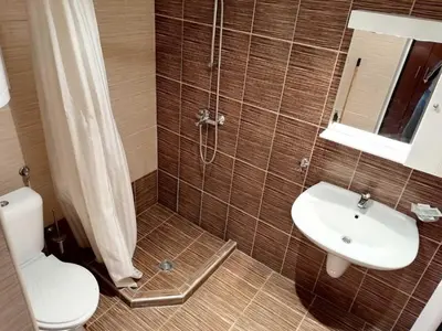a bathroom with a shower and a toilet and a sink at Apartment Dream Pamporovo in Pamporovo