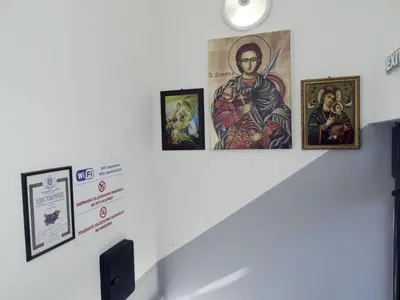 a wall with paintings and pictures on it at Apartments EMIZA in Samokov