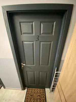 a door in a stairwell with a stair runner in front at Apartments EMIZA in Samokov
