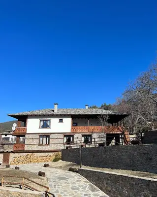 a building with a blue sky in the background at Vladimirov's House Kovachevitsa , Цяла къща in Kovachevitsa