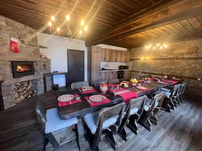 a large dining room with a long table and chairs at Vladimirov's House Kovachevitsa , Цяла къща in Kovachevitsa