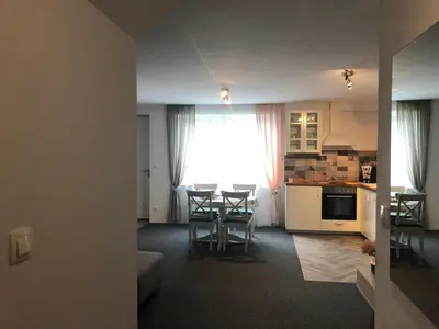 a kitchen and a living room with a table and chairs at Lavender Suite in Dragichevo