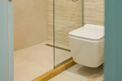 a bathroom with a toilet and a shower at Elite Business Residence with Free Gym Pass, Street Parking and Full Office Setup in Plovdiv
