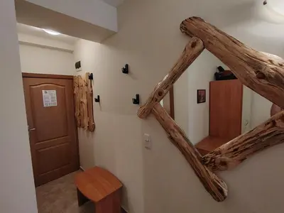 a staircase in a room with a wooden stair case at Studio apartment with mountain view at Eagle Rock complex in Beli Iskar