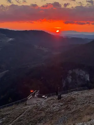 a sunset at the top of a mountain with the sun setting at Вила ИГЛИКА in Yagodina