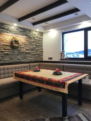 a table in a booth in a restaurant at Вила ИГЛИКА in Yagodina