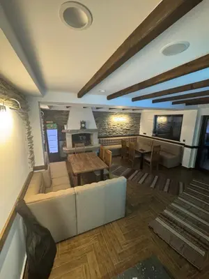a living room with a couch and a table at Вила ИГЛИКА in Yagodina