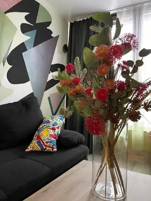 a vase filled with flowers in a living room at Intelligent Elephant Home - 1BDR Apartment by Flat Mаnager in Sofia