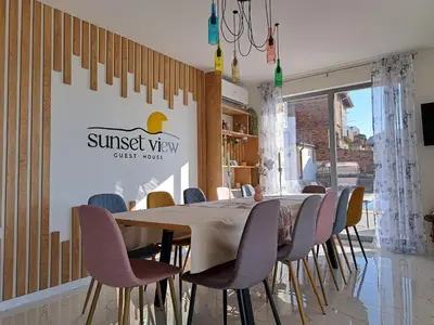a dining room with a table and chairs at Sunset view guest house in Ilindentsi