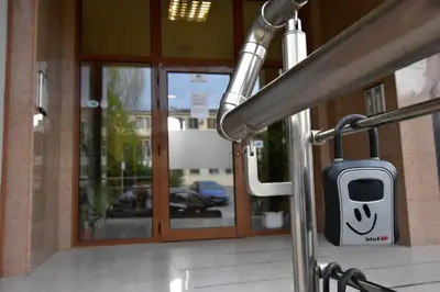 a door to a building with a cell phone holder at Panoramic Terrace City View Suite in Sofia Center in Sofia