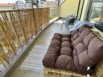 a brown couch sitting on top of a balcony at Panoramic Terrace City View Suite in Sofia Center in Sofia