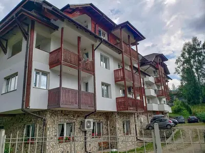 a building with red balconies on the side of it at Apart 32 Govedartsi Forest View in Govedartsi