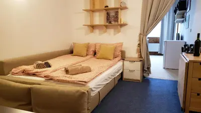 a bedroom with a large bed with yellow pillows at Apart 32 Govedartsi Forest View in Govedartsi