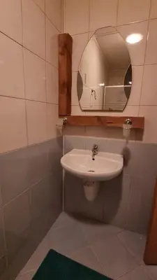 a bathroom with a sink and a mirror at Pirin Studios in Bansko