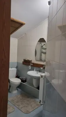 a bathroom with a sink and a toilet and a mirror at Pirin Studios in Bansko