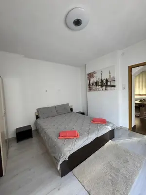 a bedroom with a bed with red pillows on it at Guest House Tanevi in Devin