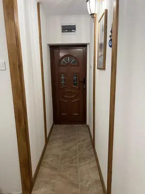 a hallway with a wooden door in a house at Guest House Tanevi in Devin