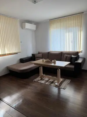 a living room with a couch and a coffee table at Guest House Tanevi in Devin