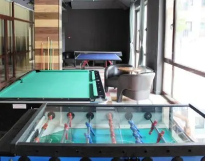 a ping pong table in a room with a pool table at BoroHome in Borovets