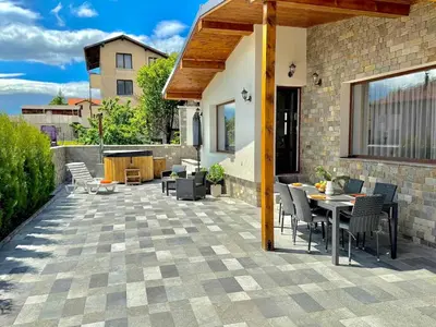 a patio with a table and chairs and a table at Вила Рафаела-Мартина in Dobrinishte