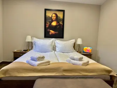 a bedroom with a bed with towels on it at Вила Рафаела-Мартина in Dobrinishte
