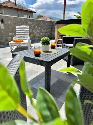 a patio with a table and two candles on it at Вила Рафаела-Мартина in Dobrinishte