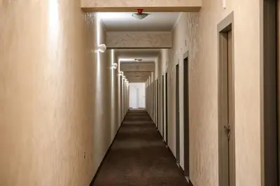 an empty corridor of an office building with a long hallway at Hotel CITY Sandanski in Sandanski