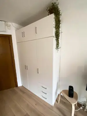 a white cupboard with a plant on top of it at Stylish apartment, very good location! in Sofia
