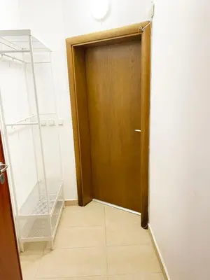 a wooden door in a room with a tile floor at Stylish apartment, very good location! in Sofia