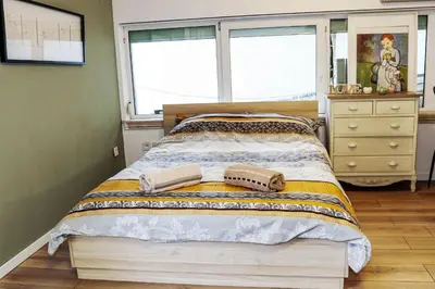 a bedroom with a bed with two towels on it at Stylish apartment, very good location! in Sofia
