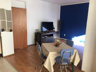 a room with a table and chairs and a television at One Bedroom Flat With Garden and Barbeque in Bansko
