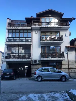 a silver car parked in front of a building at One Bedroom Flat With Garden and Barbeque in Bansko