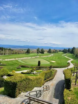 a park with a bench and a golf course at Pirin Golf SPA Studio Mountain View Compass Property in Bansko
