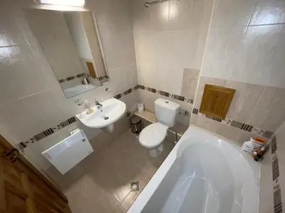 a bathroom with a tub and a toilet and a sink at Pirin Golf SPA Studio Mountain View Compass Property in Bansko
