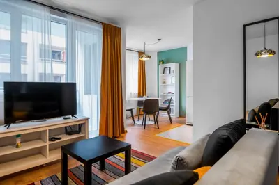 a living room with a couch and a flat screen tv at Modern&Stylish Studio in City Centre by Flat Mаnager in Sofia